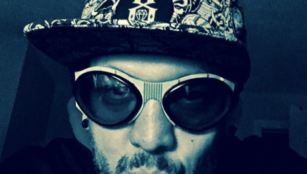 Mr. Dereloid wearing had and big bug glasses.